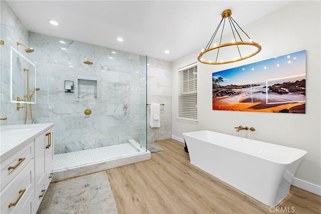 20 Becker, Ladera Ranch, CA 92694 - bathroom with a freestanding tub, wood finished floors, a marble finish shower, vanity, and recessed lighting