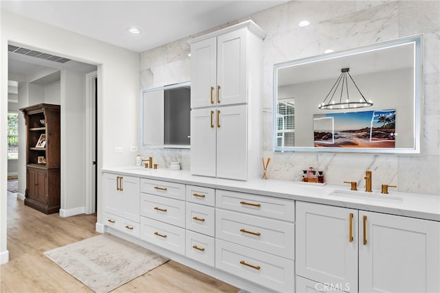 20 Becker, Ladera Ranch, CA 92694 - bathroom featuring double vanity, wood finished floors, decorative backsplash, and recessed lighting