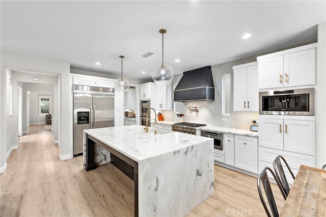 20 Becker, Ladera Ranch, CA 92694 - kitchen featuring custom exhaust hood, stainless steel appliances, light wood-style floors, white cabinets, and recessed lighting