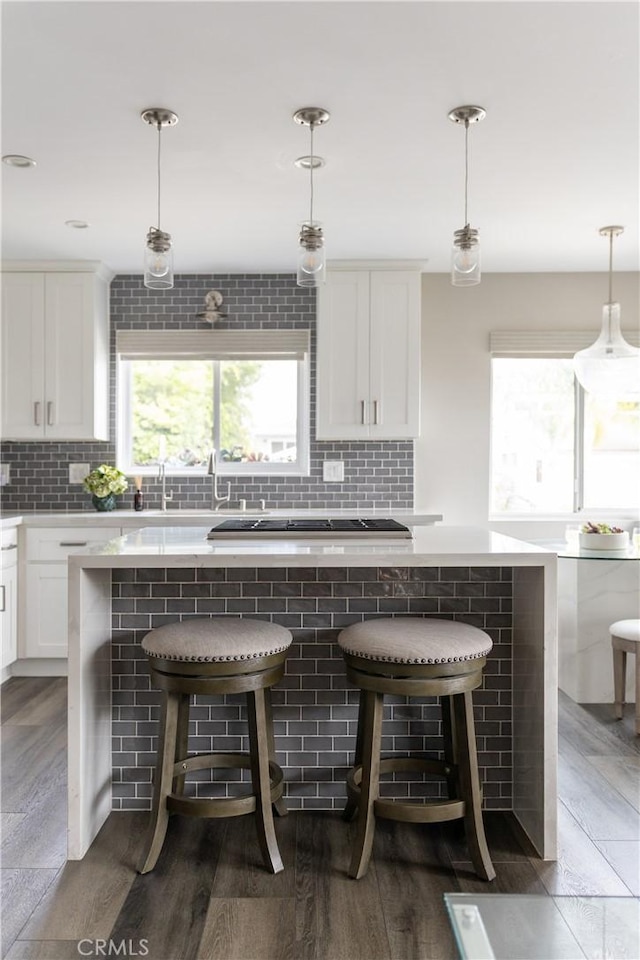 284 Chiquita St, Laguna Beach, CA 92651 - kitchen with tasteful backsplash, plenty of natural light, and white cabinetry