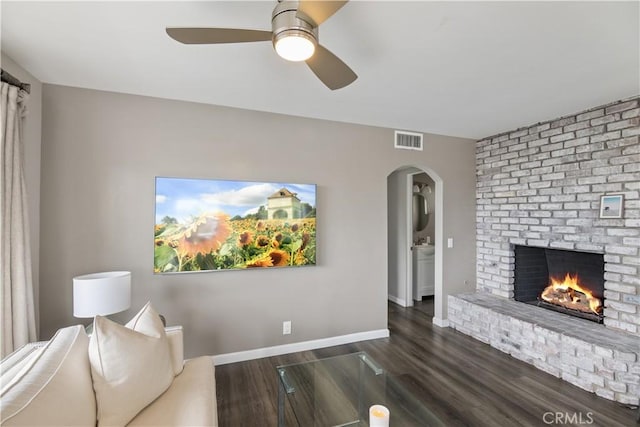 284 Chiquita St, Laguna Beach, CA 92651 - living area featuring a brick fireplace, dark wood-style floors, ceiling fan, and arched walkways