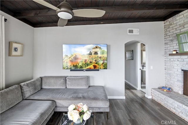 284 Chiquita St, Laguna Beach, CA 92651 - living area featuring a wood ceiling with exposed beams, arched walkways, dark wood-type flooring, a fireplace, and ceiling fan
