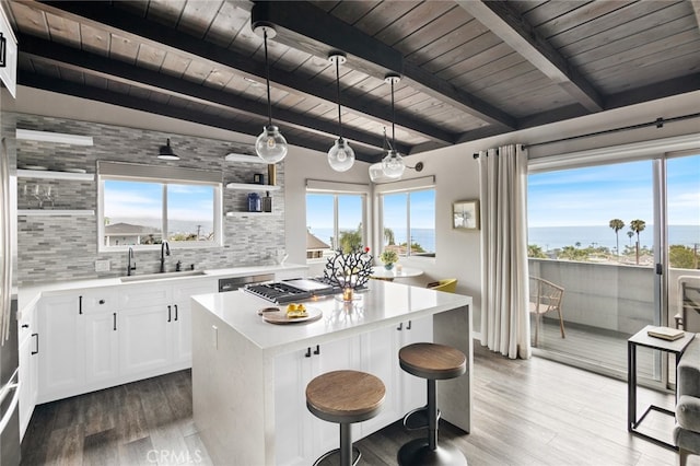 284 Chiquita St, Laguna Beach, CA 92651 - kitchen featuring wooden ceiling, backsplash, a kitchen breakfast bar, plenty of natural light, and a kitchen island