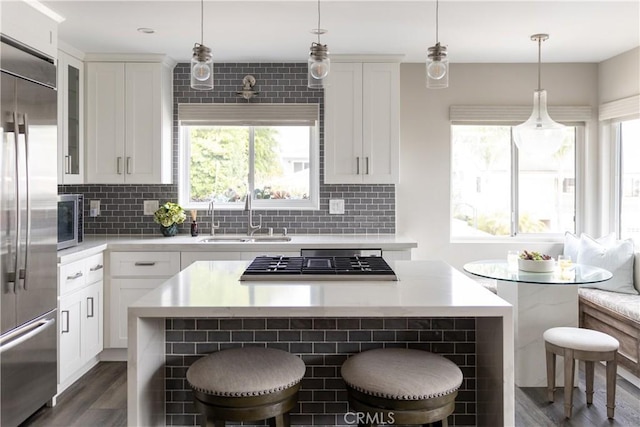 284 Chiquita St, Laguna Beach, CA 92651 - kitchen with a center island, stainless steel appliances, a breakfast bar, and light countertops