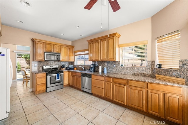 6791 Florence Pl, Rancho Cucamonga, CA 91701 - kitchen featuring stainless steel appliances, backsplash, stone counters, ceiling fan, and recessed lighting