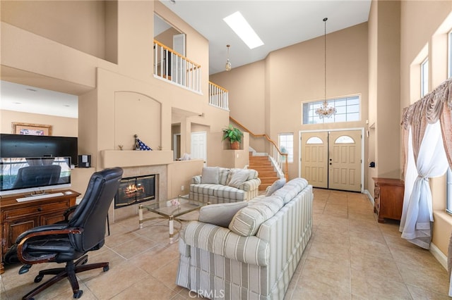 6791 Florence Pl, Rancho Cucamonga, CA 91701 - home office with a towering ceiling, a fireplace, light tile patterned floors, and a chandelier