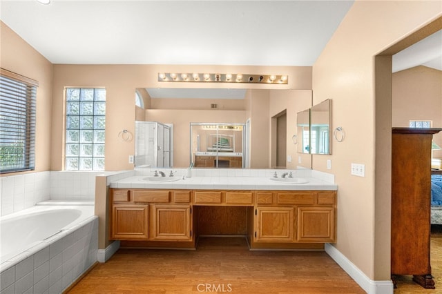 6791 Florence Pl, Rancho Cucamonga, CA 91701 - full bathroom with connected bathroom, wood finished floors, double vanity, and a bath