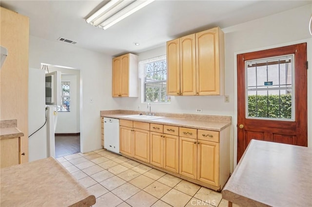 10018 San Vincente Ave, South Gate, CA 90280 - kitchen featuring light brown cabinets, white dishwasher, light tile patterned flooring, and light countertops