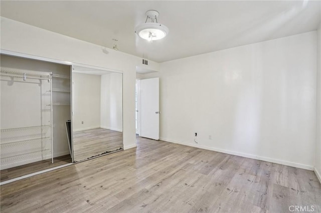 10018 San Vincente Ave, South Gate, CA 90280 - unfurnished bedroom featuring wood finished floors and a closet