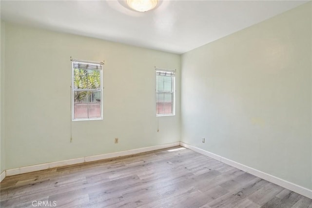 10018 San Vincente Ave, South Gate, CA 90280 - empty room with wood finished floors and baseboards