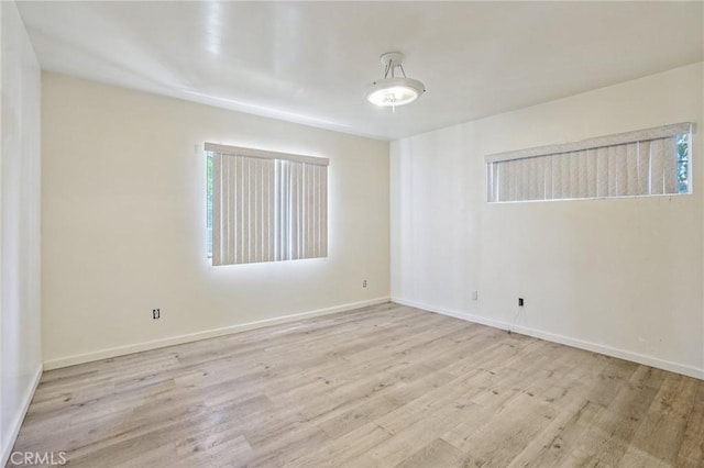 10018 San Vincente Ave, South Gate, CA 90280 - empty room with wood finished floors and baseboards
