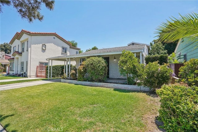 10018 San Vincente Ave, South Gate, CA 90280 - view of front of property featuring stucco siding, driveway, and a carport