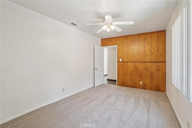 10018 San Vincente Ave, South Gate, CA 90280 - empty room with ceiling fan, wooden walls, and carpet floors