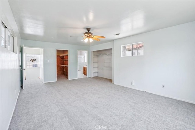 10018 San Vincente Ave, South Gate, CA 90280 - unfurnished bedroom featuring a spacious closet, carpet flooring, and ceiling fan