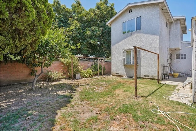 10018 San Vincente Ave, South Gate, CA 90280 - back of property featuring a fenced backyard, stucco siding, and crawl space