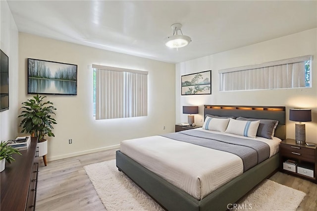 10018 San Vincente Ave, South Gate, CA 90280 - bedroom featuring light wood-style flooring and baseboards