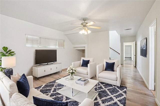 10018 San Vincente Ave, South Gate, CA 90280 - living room featuring light wood finished floors, ceiling fan, and stairway
