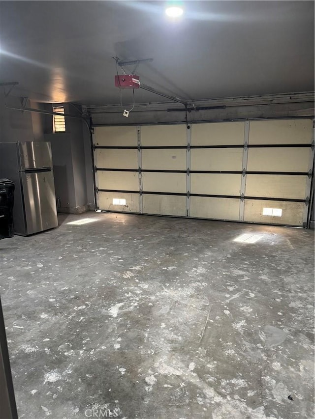 7445 Laurelgrove Ave Unit 2, North Hollywood, CA 91605 - garage featuring freestanding refrigerator and a garage door opener