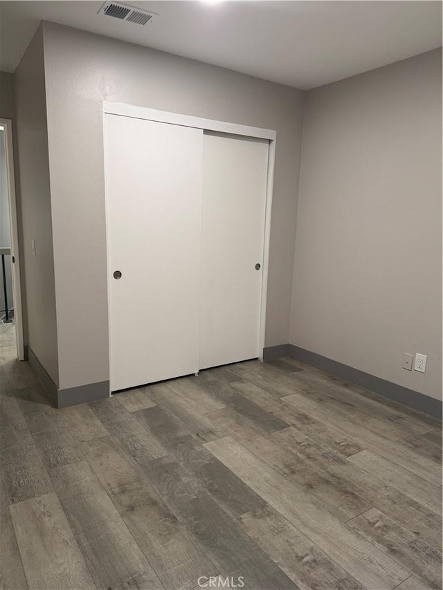 7445 Laurelgrove Ave Unit 2, North Hollywood, CA 91605 - unfurnished bedroom with wood finished floors and a closet