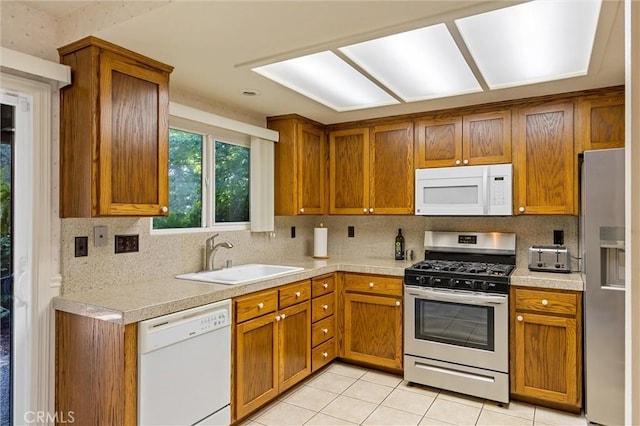 2665 Waverly Ct, Chico, CA 95973 - kitchen featuring stainless steel appliances, brown cabinetry, light countertops, and tasteful backsplash