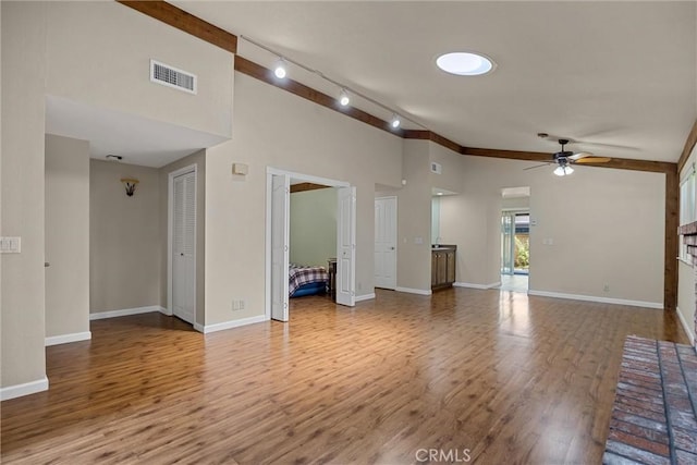2665 Waverly Ct, Chico, CA 95973 - unfurnished living room with ceiling fan, wood finished floors, rail lighting, and high vaulted ceiling
