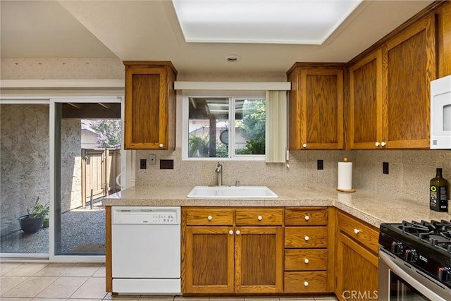 2665 Waverly Ct, Chico, CA 95973 - kitchen featuring dishwasher, brown cabinets, and light countertops
