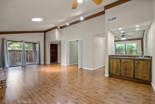 2665 Waverly Ct, Chico, CA 95973 - unfurnished living room with a ceiling fan, track lighting, wood finished floors, and high vaulted ceiling