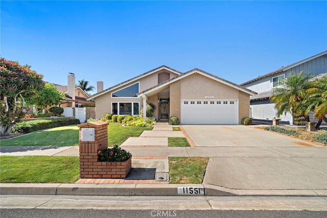 11551 Gladstone Cir, Fountain Valley, CA 92708 - mid-century modern home with an attached garage, driveway, and stucco siding