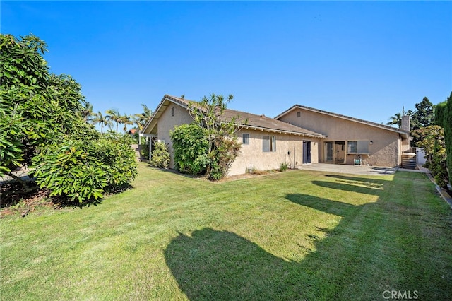 11551 Gladstone Cir, Fountain Valley, CA 92708 - rear view of house with stucco siding, a lawn, and a patio area
