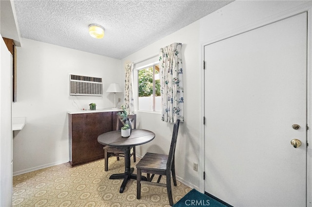 11551 Gladstone Cir, Fountain Valley, CA 92708 - home office with a wall mounted air conditioner, a textured ceiling, and light flooring