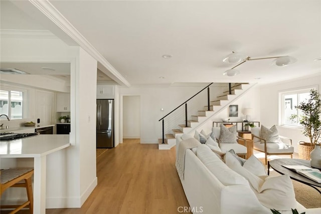 1585 Miramar Dr, Newport Beach, CA 92661 - living area with stairs, light wood finished floors, and ornamental molding