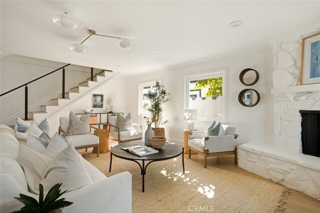 1585 Miramar Dr, Newport Beach, CA 92661 - living area featuring stairs, wood finished floors, ornamental molding, and a stone fireplace