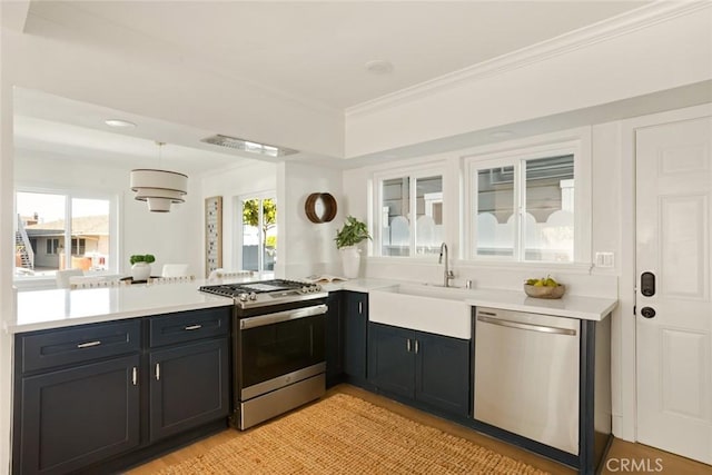 1585 Miramar Dr, Newport Beach, CA 92661 - kitchen with stainless steel appliances, a peninsula, light countertops, healthy amount of natural light, and ornamental molding