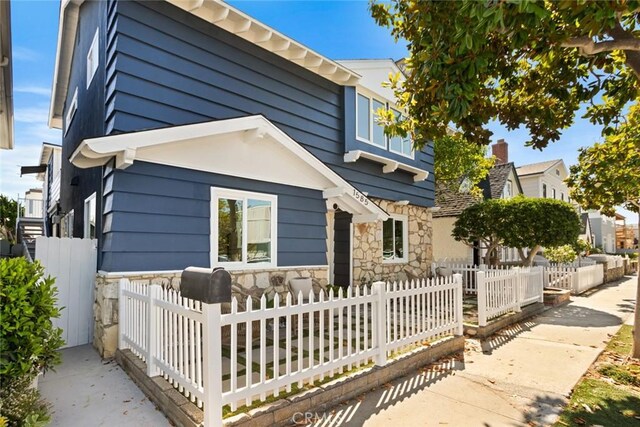 1585 Miramar Dr, Newport Beach, CA 92661 - view of front of home with stone siding and a fenced front yard