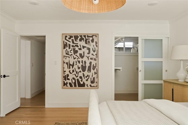 1585 Miramar Dr, Newport Beach, CA 92661 - bedroom featuring ornamental molding, light wood-type flooring, and a walk in closet