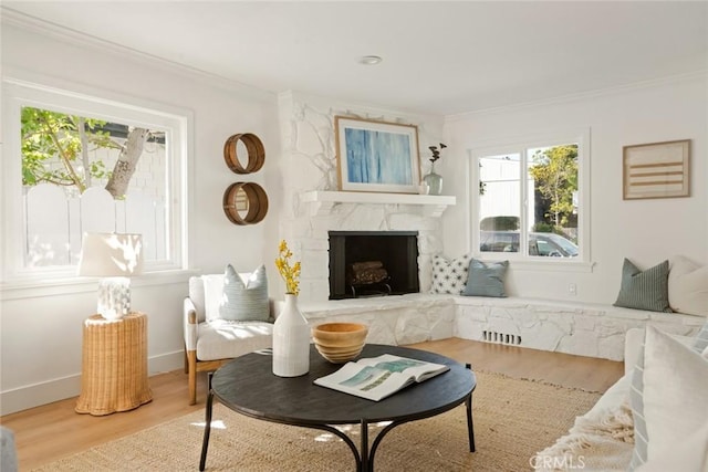1585 Miramar Dr, Newport Beach, CA 92661 - living area featuring ornamental molding, healthy amount of natural light, wood finished floors, and a stone fireplace