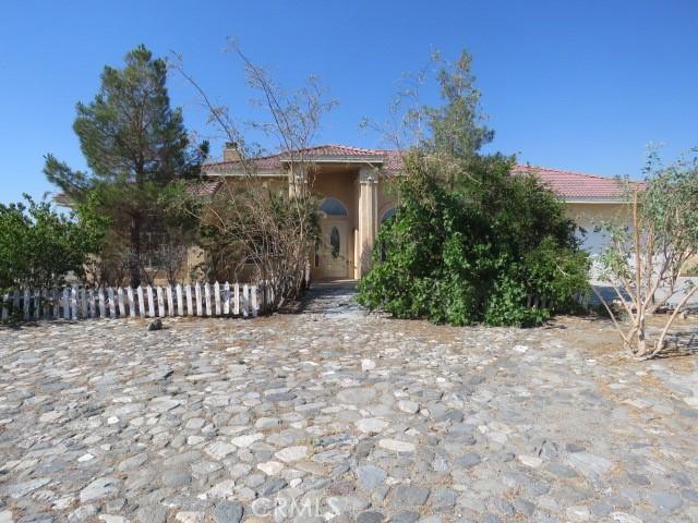 2425 Tokay Rd, Phelan, CA 92371 - view of front of home with a tile roof, a chimney, and stucco siding