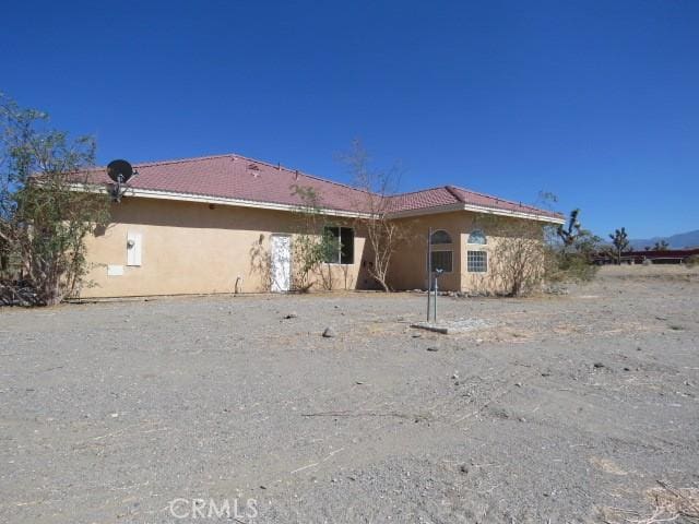 2425 Tokay Rd, Phelan, CA 92371 - rear view of house featuring stucco siding and a tiled roof