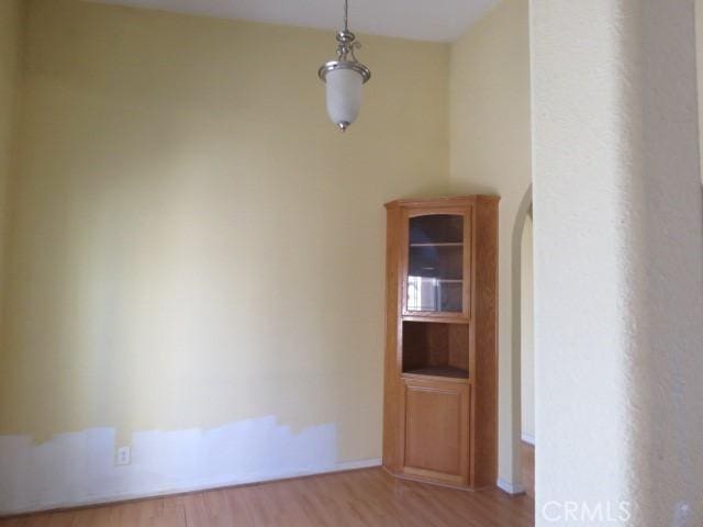 2425 Tokay Rd, Phelan, CA 92371 - unfurnished dining area with wood finished floors and arched walkways