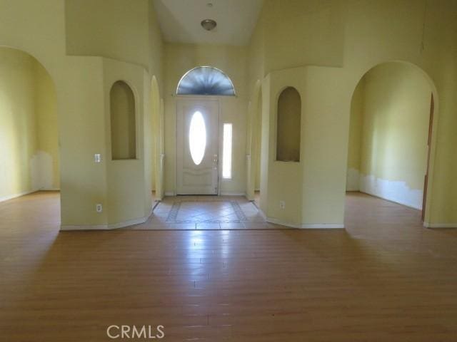 2425 Tokay Rd, Phelan, CA 92371 - entryway with wood finished floors, a towering ceiling, and arched walkways