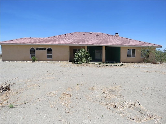 2425 Tokay Rd, Phelan, CA 92371 - back of property featuring a tiled roof, a chimney, and stucco siding