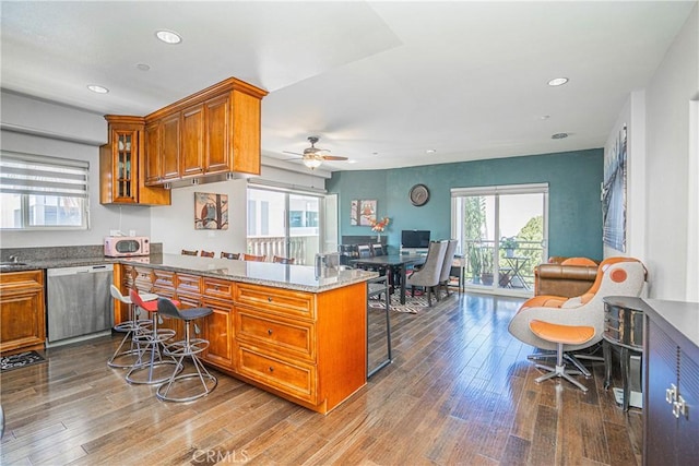 1026 S Oxford Ave Unit 206, Los Angeles, CA 90006 - kitchen with dishwasher, brown cabinets, a kitchen breakfast bar, wood finished floors, and recessed lighting