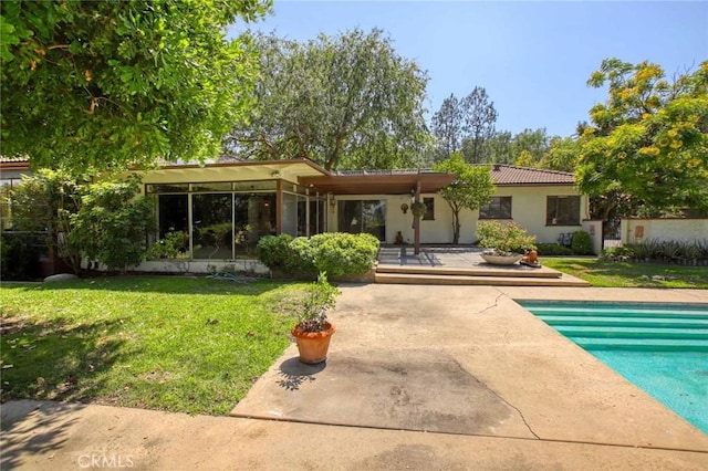 1075 Pine Oak Ln, Pasadena, CA 91105 - rear view of property with a patio area, a lawn, an outdoor pool, a tile roof, and stucco siding