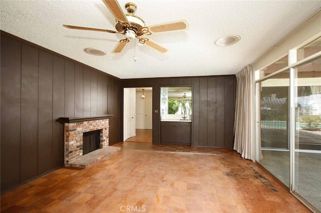 1075 Pine Oak Ln, Pasadena, CA 91105 - foyer entrance featuring a textured ceiling, wood walls, ceiling fan, a fireplace, and crown molding