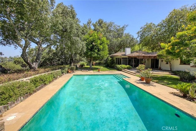 1075 Pine Oak Ln, Pasadena, CA 91105 - outdoor pool with view of wooded area and a patio area