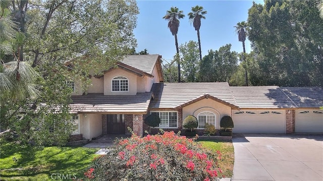 2290 Decade Ct, Riverside, CA 92506 - traditional-style house with driveway, stucco siding, a garage, and brick siding