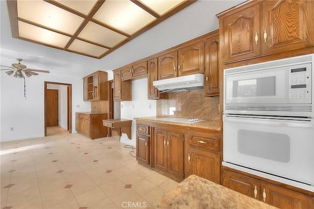 2290 Decade Ct, Riverside, CA 92506 - kitchen featuring white appliances, under cabinet range hood, brown cabinets, and ceiling fan
