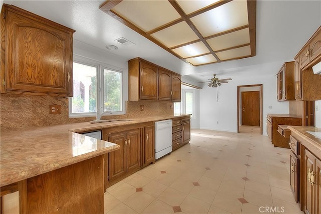 2290 Decade Ct, Riverside, CA 92506 - kitchen featuring dishwasher, brown cabinetry, ceiling fan, and decorative backsplash