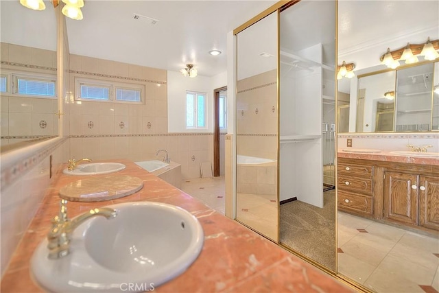 2290 Decade Ct, Riverside, CA 92506 - full bath featuring double vanity, tile patterned floors, tile walls, and a tub to relax in