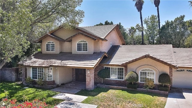 2290 Decade Ct, Riverside, CA 92506 - view of front facade featuring stucco siding, a front yard, an attached garage, and brick siding